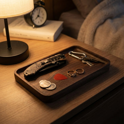 Wooden tray with a knife, coins, keys, and a heart-shaped object on a wooden surface.