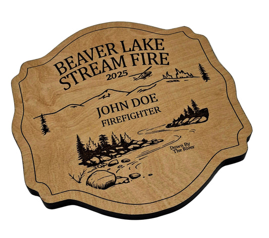 Wooden plaque for fire fighters with engraved text and illustrations on a gray background