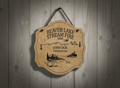 Wooden Fire plaque with engraved text and nature design on a wooden background